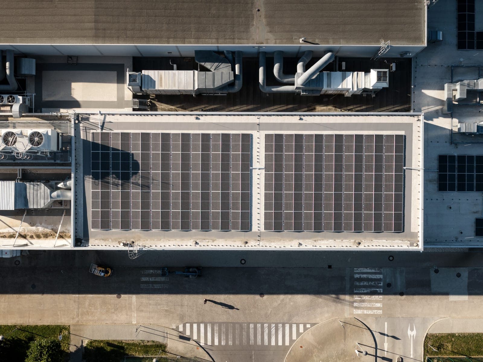 Top-down drone view of a hall roof with a solar array