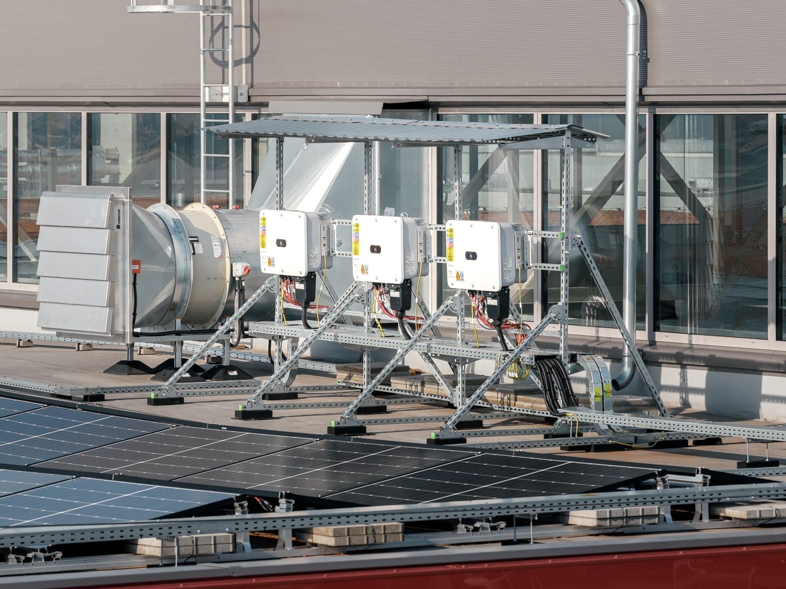 Three inverters on a steel structure on the roof of the store