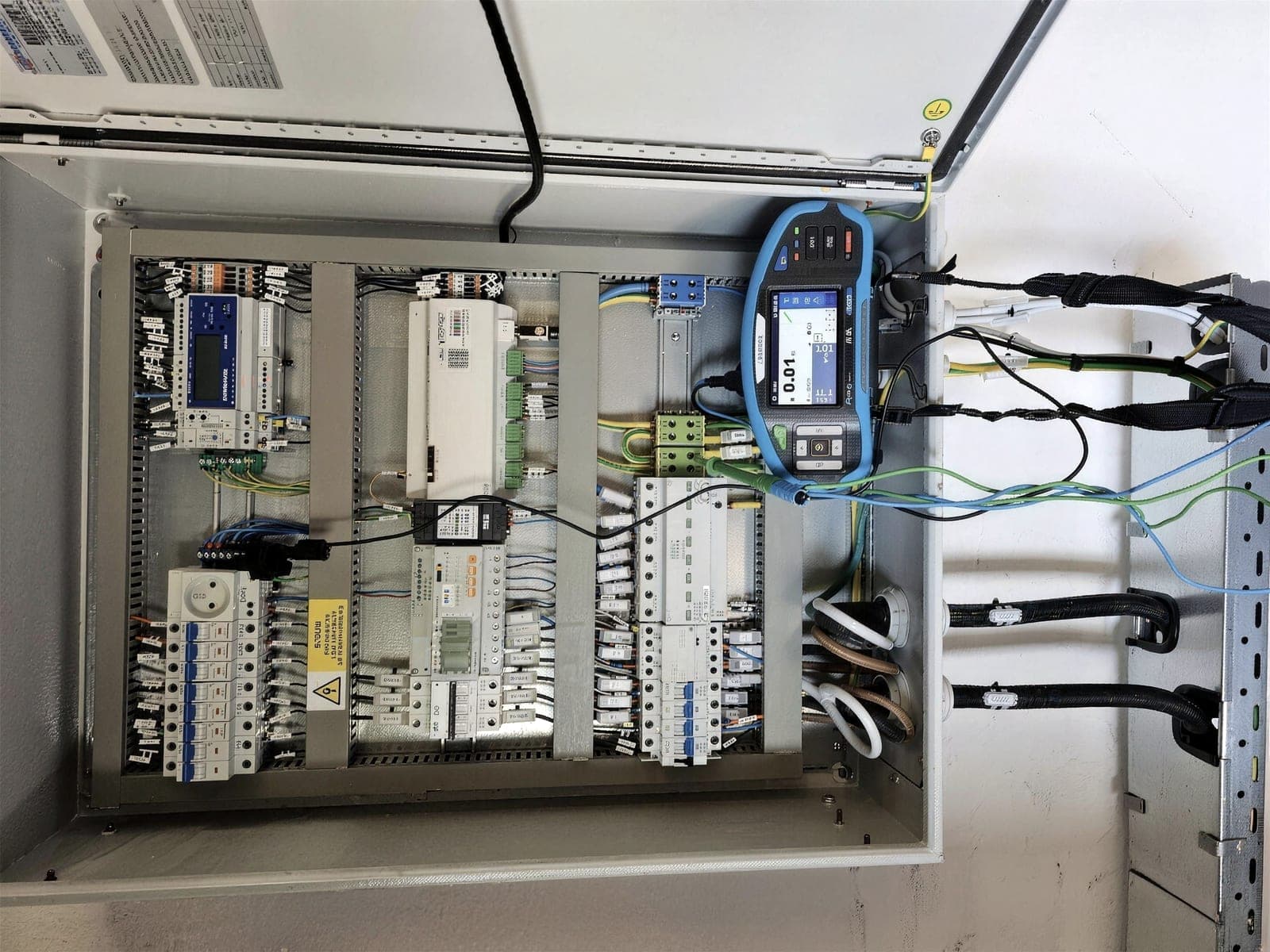 Switchboard with a measuring instrument connected during routine verification