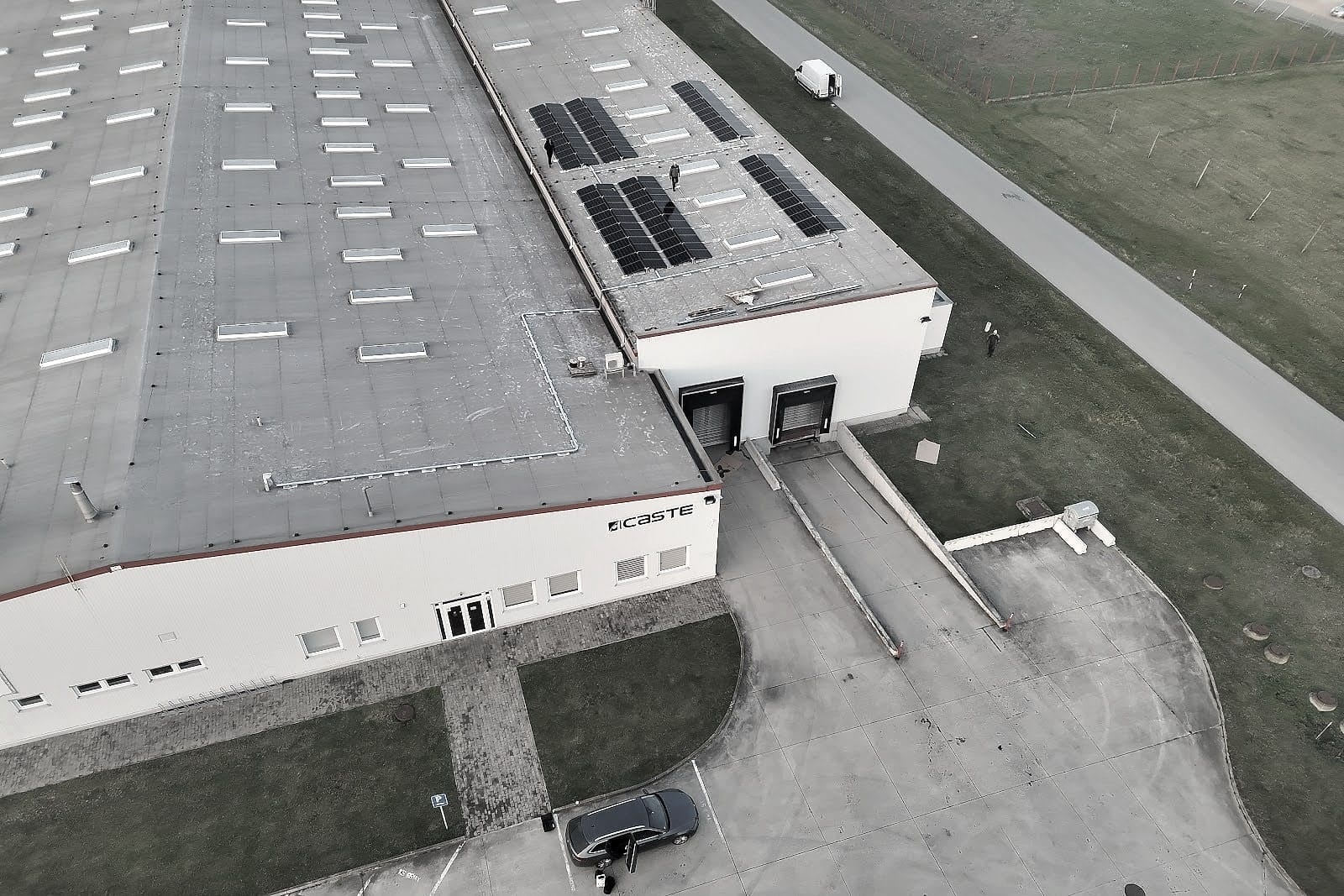 Aerial photo of an industrial site in Kechnec: a hall with solar panels on the roof, access road and car park